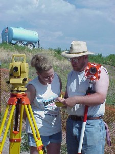 Teaching a young volunteer to use the total station surveying instrument.